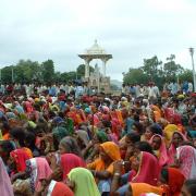 An audience of women in bright clothes