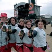 Amnesty volunteers holding their cell phones at a concert